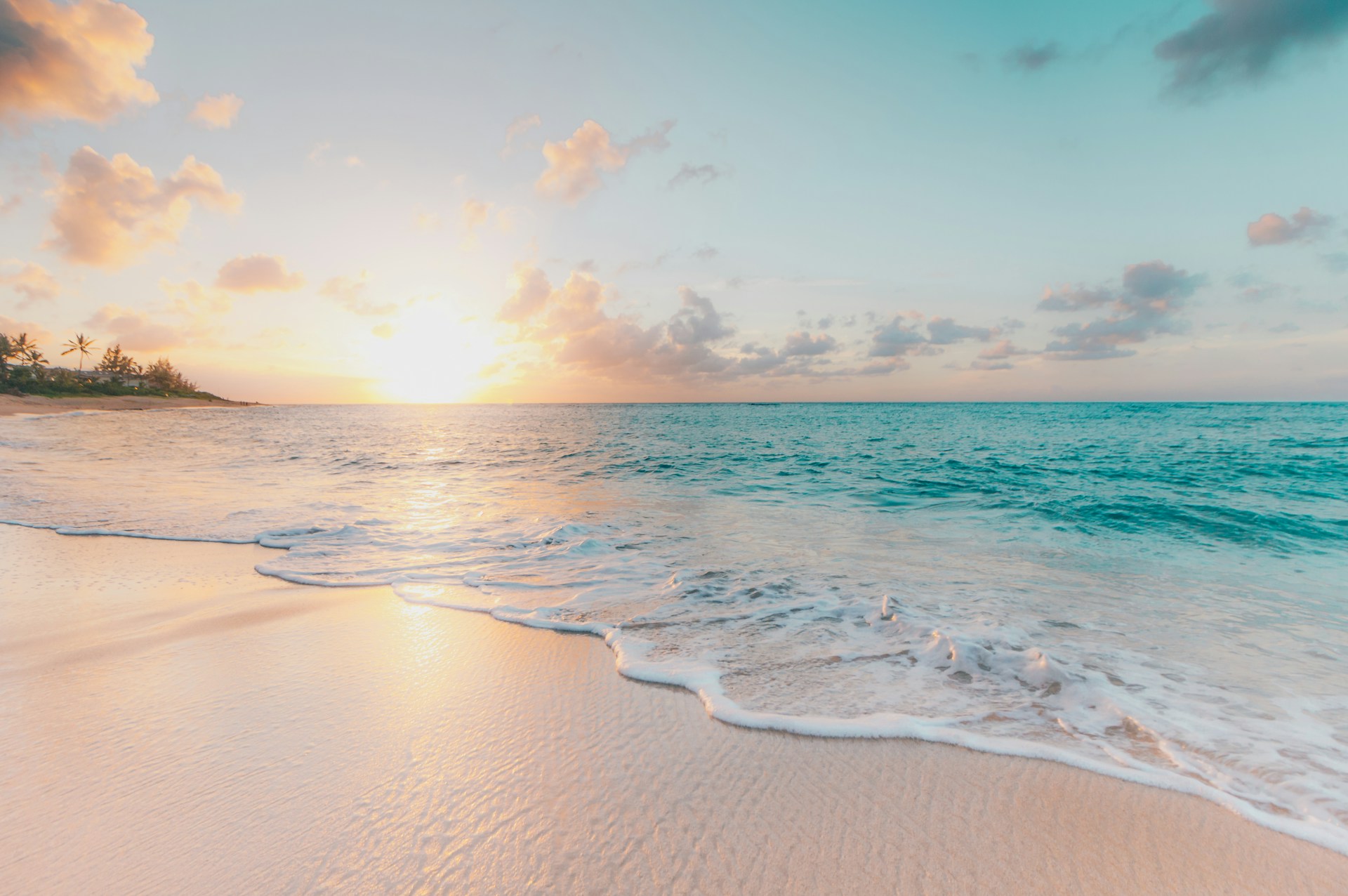 Bright shoreline with clear blue water